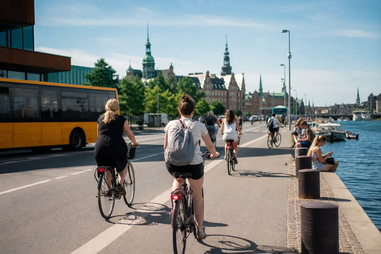 AI-foto van een realistische Kopenhaagse fietsscene met toeristen, openbaar vervoer en een stedelijke duurzame sfeer als beeld bij CopenPay.